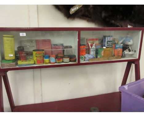 A fine and wide ranging collection of vintage packaging contained within a glazed display case, including auto products such 