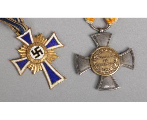 A World War II German Third Reich mothers cross first class in gold along with an Imperial German silver gilt cross medal Ver