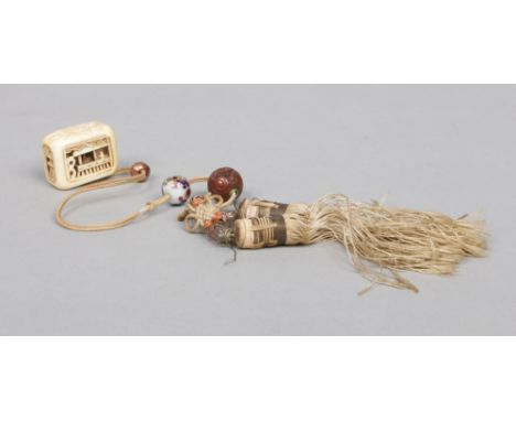 A Japanese Meiji period carved ivory netsuke decorated with figures and buildings and incised with a phoenix, signed. Support