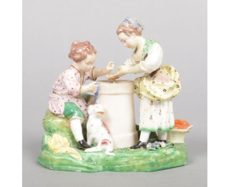 A Derby figure group modelled as two children playing hazard after a painting by Francois Boucher. Painted in coloured enamel
