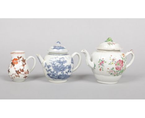 An 18th century Chinese famille rose teapot and cover along with a blue and white example and a cream jug painted in coloured