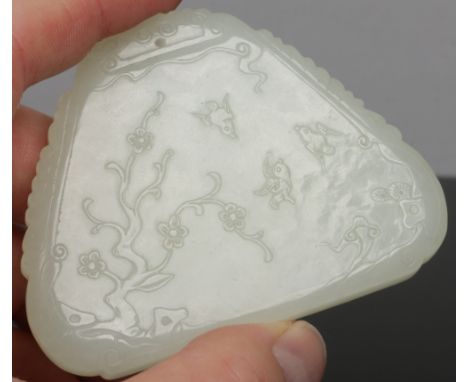 A Chinese carved pale celadon jade chime of triangular form. Decorated in shallow relief with a landscape and figures to one 
