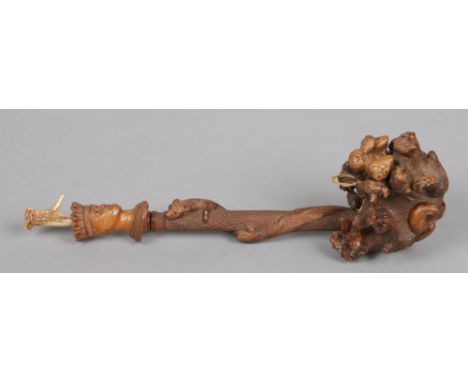 A 19th century large rootwood pipe with antler mouthpiece. Carved with a squirrel and a bust of a king, 49cm.