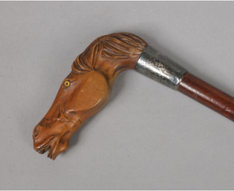 A George V walking stick with silver collar. The handle finely carved from boxwood in the form of a horses head and having gl