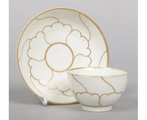 A Worcester teabowl and saucer decorated with the Queen's pattern in gilt c1770, saucer 12cm diameter.Condition report intend