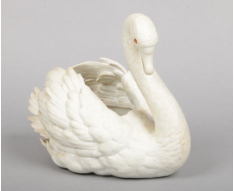 A Parian planter modelled in the form of a swan and with glass inset eyes, 28cm high.Condition report intended as a guide onl