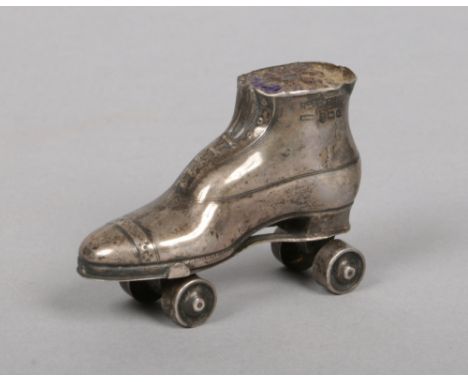 An Edwardian novelty silver pin cushion formed as a roller skate and with working wheels. Assayed Birmingham 1909 probably by