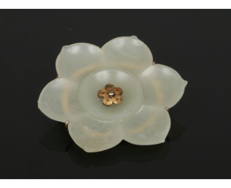 A silver mounted carved celadon jade brooch formed as a lotus flower, 4.75cm wide.