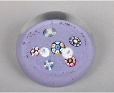 A Paul Ysart paperweight set with five complex canes on a lilac speckled ground, Harland period, 7.25cm wide.&nbsp;Condition 
