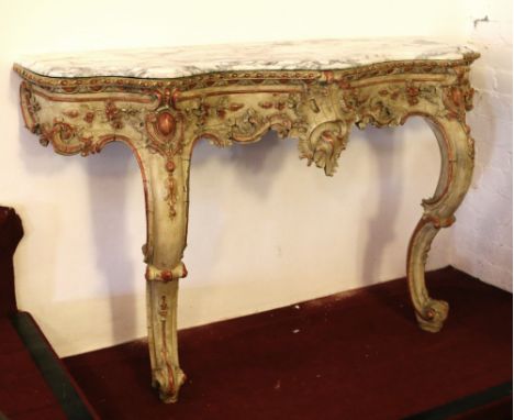 A 19th century French carved and painted marble top console table of serpentine form and raised on scroll supports, 142cm wid