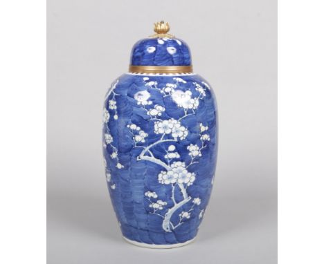 A tall 19th century Chinese blue and white jar and cover. Painted in underglaze blue with the prunus blossom design. With lat