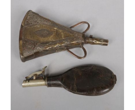 A 19th century leather powder flask with spring loaded mechanism along with an eastern copper and brass example, 20cm.