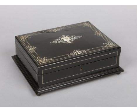 A 19th century French fitted and ebonized games compendium. With ivory inlay having penwork decoration and housing mother of 