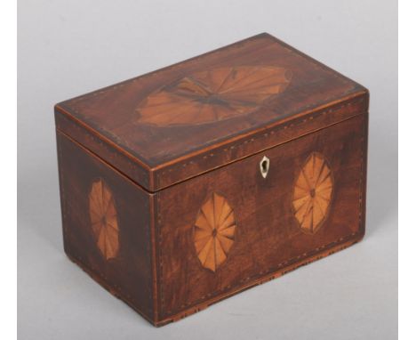 A Regency mahogany tea caddy with strung inlay and fan patera, 16.75cm wide.&nbsp;