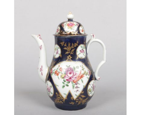 A Worcester blue ground coffee pot and cover. With gilt framed reserved containing polychrome flowers, the spout and handle e