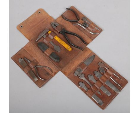 A German multi tool pocket knife in fitted leather case. With 10 detachable steel tools and a further 5 accoutrements.&nbsp;