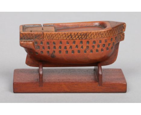 An 18th century novelty carved treen snuff box. With hinged cover and formed as a three deck gunship on separate wooden plint