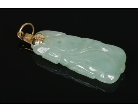 A Chinese carved pale celadon jade pendant with 14 carat gold mount, 36mm.