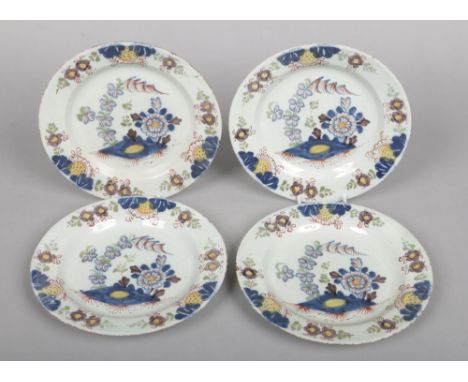A set of four 18th century Lambeth polychrome delft plates. Painted with leaves and flowers in blue, green yellow and mangane