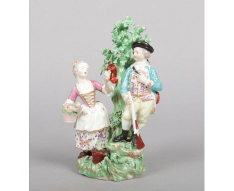 A Derby allegorical figure group emblematic of Spring and Winter. Coloured in enamels and modelled as a hunter with a gun and