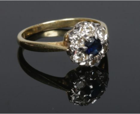 An 18 carat gold sapphire and diamond cluster ring. Size K 1/2.