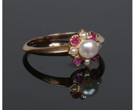 An early 20th century ruby spinel and pearl ring of cruciform setting, size P.