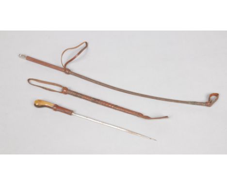 A horn handled sword stick / riding crop with leather mounts along with another riding crop.