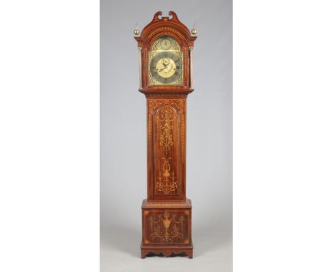 An Edwardian Sheraton revival marquetry inlaid mahogany longcase clock. With a brass arch top dial ornamented with spandrels,