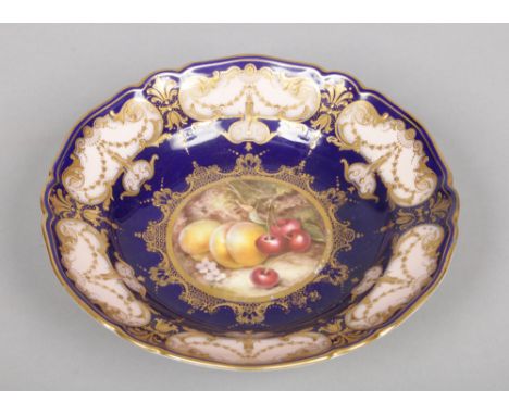 A Royal Worcester shallow comport. With wide cobalt blue, salmon and gilt border framing a central roundel painted with fruit