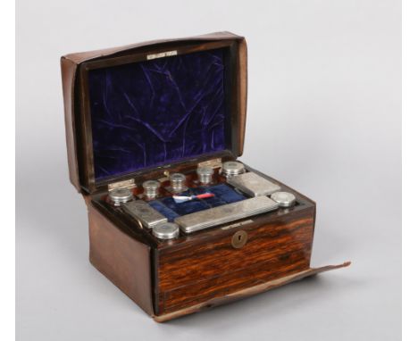 A Victorian coromandel fitted vanity box and accoutrements in tooled leather case. With silver mounted glass bottles by Willi