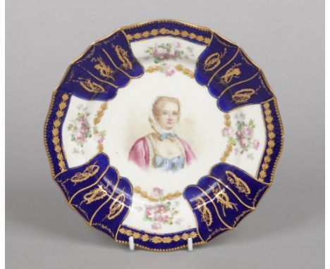 An 18th century Sevres plate with scalloped rim and ozier mould edge. With a gros bleu and gilt border, painted with roses an