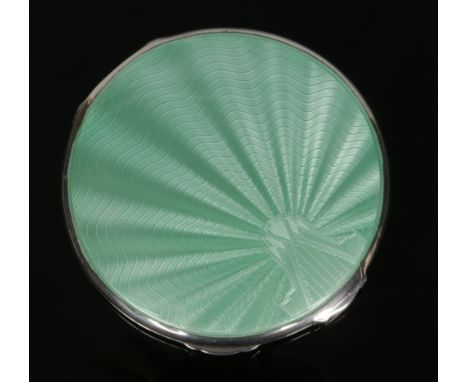 An Art Deco silver and green guilloche enamel powder compact by William Neale &amp; Sons Ltd. Assayed Birmingham 1938, 8.25cm