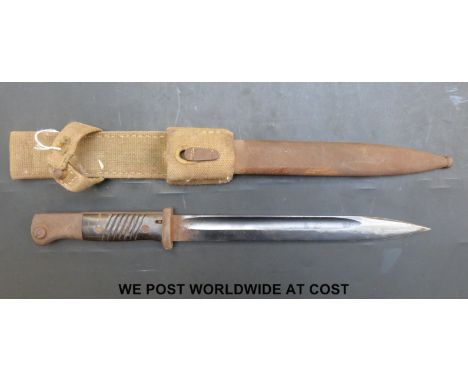 A German bayonet marked F W Heller and 7040K in steel scabbard with canvas frog (overall length 40.5cm)