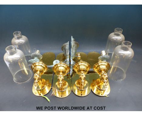 A set of four brass wall light fittings, a further pair with bronzed effect and a green glass oil lamp 