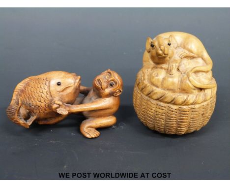 A cherry wood netsuke in the form of a monkey and carp, together with a small box with oriental carving of a rat on a basket 