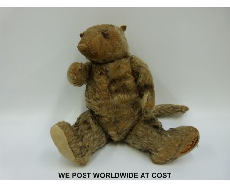 Steiff mohair bear in the form of a possum with straw filled body, cocked feet and wrists and shaved snout (40cm tall)