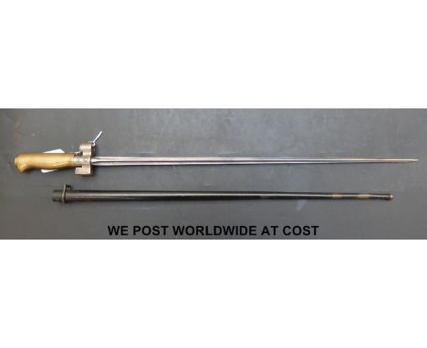 An 1886/15 pattern French stick bayonet with 52cm cruciform blade stamped C8p with brass handle complete with scabbard