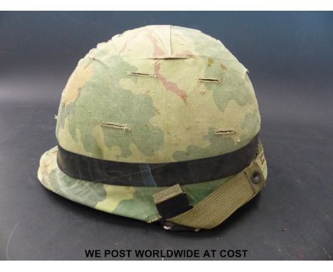 A US Army Vietnam era steel helmet with cover and inner, marked Steinberg Brothers inc. dated 24 Feb 1972