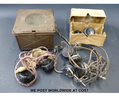 A military radio speaker and headphones