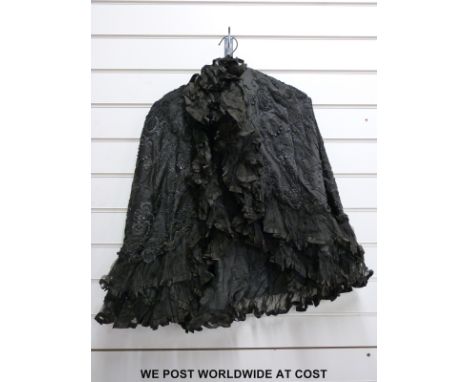 A ladies black evening cloak with beadwork decoration