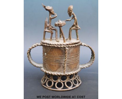 An Ashanti figural cup with two figures playing a game to the top (18cm tall) 