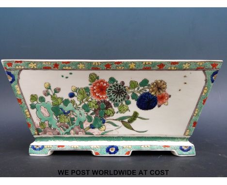 A Chinese flower trough of graduated rectangular form decorated in green, red and blue enamels with insects and ground flower