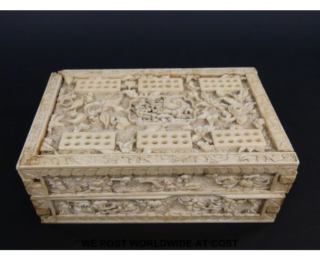 A  19thC Chinese carved ivory cribbage board which when folded forms a box for playing cards and markers, all over carved in 