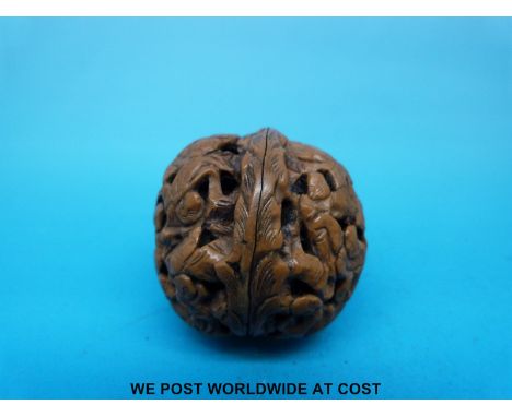 A Japanese Meiji period walnut netsuke with carved decoration
