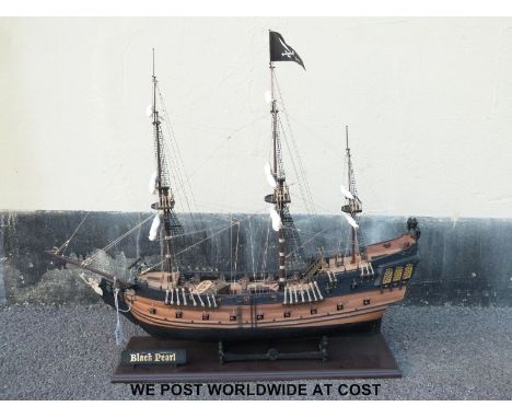 A scratch/ kit built model of The Pirates of the Caribbean's 'Black Pearl' pirate ship with four files of related magazines, 