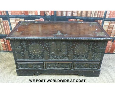 A 19thC Indian brass bound and embellished hardwood trunk over three drawers, probably and marriage chest (L115cm x W51cm w x