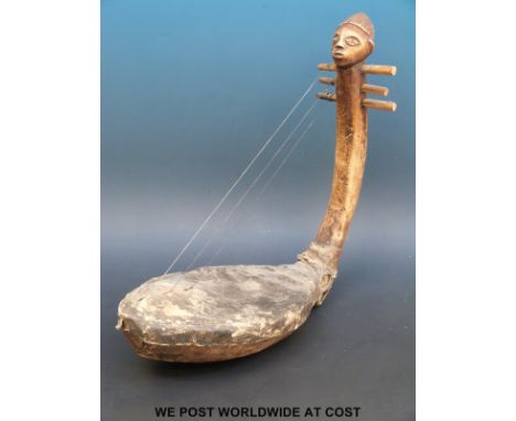 An African tribal figural musical string instrument (length 49cm)