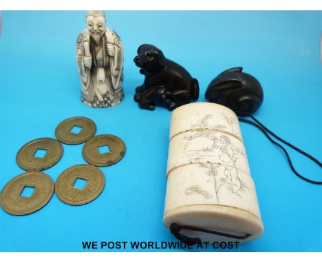 A bone netsuke of a scribe, two wooden netsukes, one dog and the other a rabbit together with a bone inro with carved geisha 