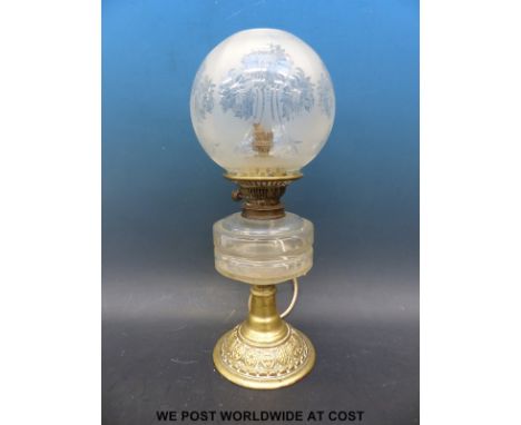 A brass oil lamp converted to electricity with chrysanthemums etched to glass shade 