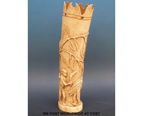 A 19thC African ivory tusk carved with stylized figures of men hunting an ostrich (31cm tall)